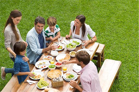 family outdoor eating - Family and friends gather for picnic Stock Photo - Premium Royalty-Free, Code: 632-08001657