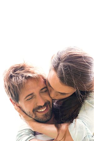 Young woman kissing boyfriend Stock Photo - Premium Royalty-Free, Code: 632-08129972