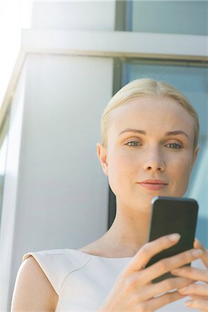 simsearch:632-07161246,k - Woman looking at smartphone Stock Photo - Premium Royalty-Free, Code: 632-08129984