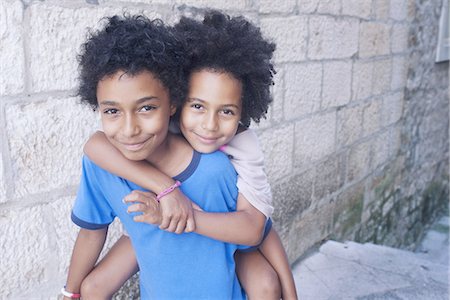 piggyback brothers - Young siblings embracing outdoors, portrait Stock Photo - Premium Royalty-Free, Code: 632-08130148