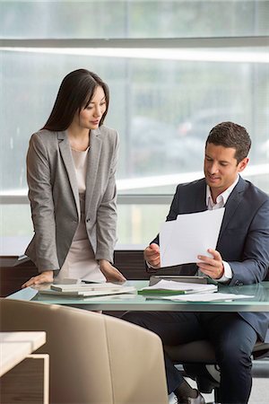 Manager reviewing document with assistant Stock Photo - Premium Royalty-Free, Code: 632-08130195