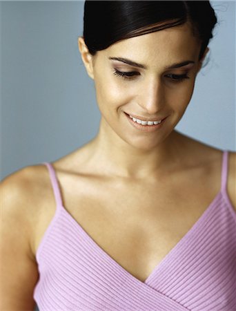 simsearch:632-08130128,k - Woman in tank top smiling, looking down, portrait Stock Photo - Premium Royalty-Free, Code: 632-08130232