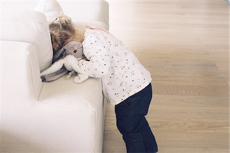 sulky tantrum - Little girl hiding her face in sofa cushions Stock Photo - Premium Royalty-Free, Code: 632-08227595