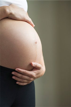 simsearch:632-05760692,k - Woman cradling pregnant belly Stock Photo - Premium Royalty-Free, Code: 632-08227758