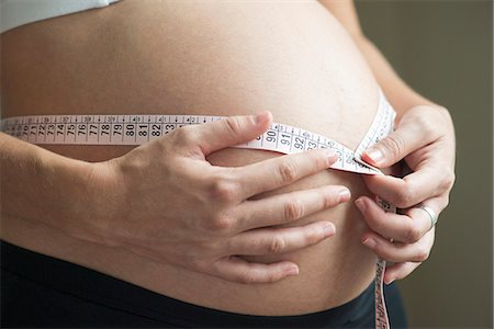 simsearch:632-05760692,k - Pregnant woman measuring waistline Stock Photo - Premium Royalty-Free, Code: 632-08227762