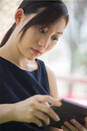 simsearch:632-07161246,k - Young woman using digital tablet Stock Photo - Premium Royalty-Free, Code: 632-08331462