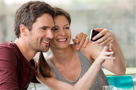 simsearch:632-07674444,k - Couple posing for smartphone selfie Stock Photo - Premium Royalty-Free, Code: 632-08331573
