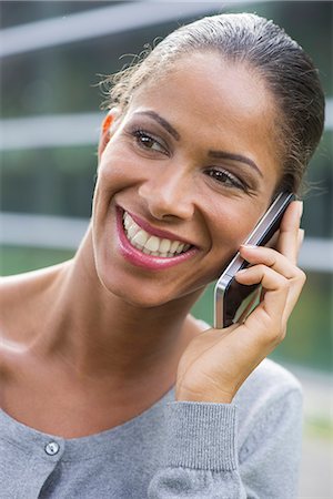 simsearch:632-05760692,k - Woman talking on cell phone and smiling cheerfully Stock Photo - Premium Royalty-Free, Code: 632-08331655