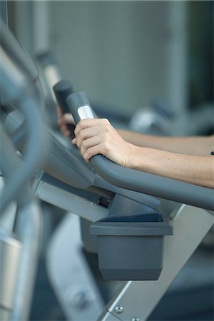 exercise machine - Woman using exercise machine in fitness club, cropped Stock Photo - Premium Royalty-Free, Code: 632-08545814
