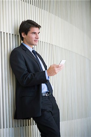 simsearch:632-05400935,k - Businessman text messaging while taking a break Stock Photo - Premium Royalty-Free, Code: 632-08698346