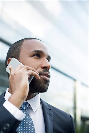 simsearch:632-05400935,k - Businessman talking on cell phone outdoors Stock Photo - Premium Royalty-Free, Code: 632-08698544