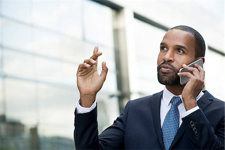 simsearch:6109-06685044,k - Businessman talking on cell phone outdoors Stock Photo - Premium Royalty-Free, Code: 632-08698608