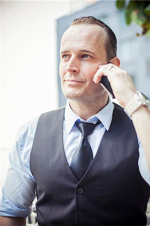 simsearch:649-07520071,k - Businessman using cell phone, portrait Stock Photo - Premium Royalty-Free, Code: 632-08886652