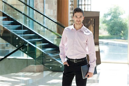 simsearch:632-08130128,k - Young businessman standing in hotel lobby Stock Photo - Premium Royalty-Free, Code: 632-08886788