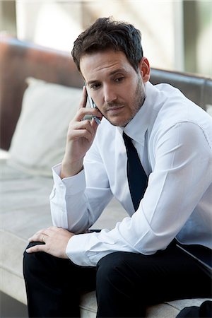 simsearch:632-05400935,k - Businessman talking on cell phone in hotel lobby Stock Photo - Premium Royalty-Free, Code: 632-08886802