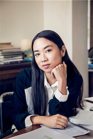 simsearch:632-08130128,k - Woman sitting at desk in office, portrait Stock Photo - Premium Royalty-Free, Code: 632-08886936