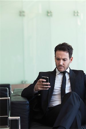 simsearch:632-05400935,k - Executive looking at cell phone with concerned look Stock Photo - Premium Royalty-Free, Code: 632-08886951