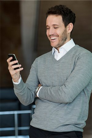 simsearch:632-05400935,k - Businessman relaxing with smartphone Stock Photo - Premium Royalty-Free, Code: 632-08887017