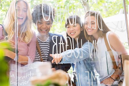 simsearch:614-06896739,k - Young women looking through shop window together Stock Photo - Premium Royalty-Free, Code: 632-08993584