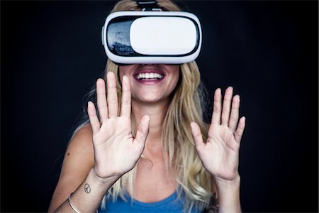 Young woman using virtual reality simulator Stock Photo - Premium Royalty-Free, Code: 632-09021538