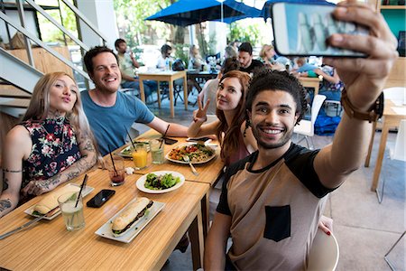 simsearch:632-07674444,k - Man taking selfie with friends Stock Photo - Premium Royalty-Free, Code: 632-09039684
