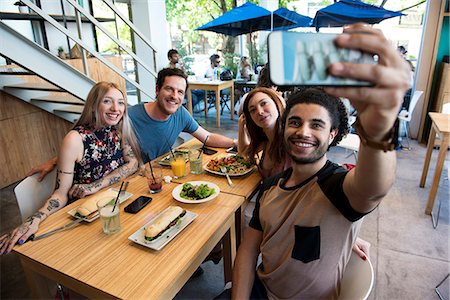 simsearch:632-07674444,k - Man taking selfie with friends Stock Photo - Premium Royalty-Free, Code: 632-09039682