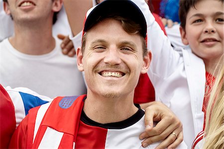 simsearch:614-06718194,k - Football supporter smiling at match, portrait Stock Photo - Premium Royalty-Free, Code: 632-09130156