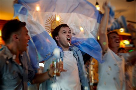 simsearch:628-05817772,k - Argentinian football fans celebrating in bar Stock Photo - Premium Royalty-Free, Code: 632-09130200