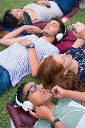 College students relaxing on grass between classes Stock Photo - Premium Royalty-Free, Code: 632-09157978
