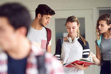 simsearch:614-06973669,k - Students studying together in corridor Stock Photo - Premium Royalty-Free, Code: 632-09157996