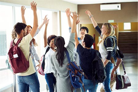 simsearch:614-06973669,k - Group of students standing in a circle with hands raised in the air Stock Photo - Premium Royalty-Free, Code: 632-09158025