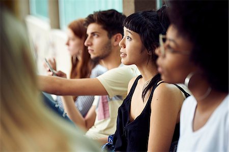 simsearch:614-06973669,k - Students sitting in a row, looking up attentively Stock Photo - Premium Royalty-Free, Code: 632-09158064