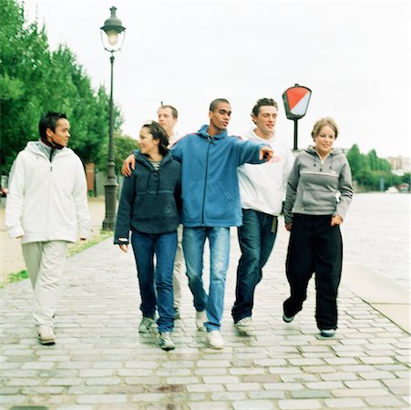 Six young people walking together on cobblestones Stock Photo - Premium Royalty-Free, Code: 632-01137045