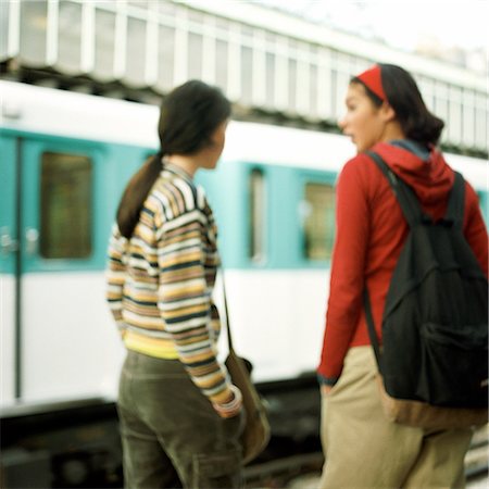 preteen tube - Two teenagers waiting on platform, rear view, blurred Stock Photo - Premium Royalty-Free, Code: 632-01137057