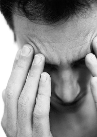 dreading - Man touching forehead with fingers, close-up, black and white. Stock Photo - Premium Royalty-Free, Code: 632-01137917