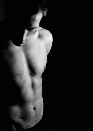 Barechested man looking down, partial view, waist up, black and white. Stock Photo - Premium Royalty-Free, Code: 632-01137911