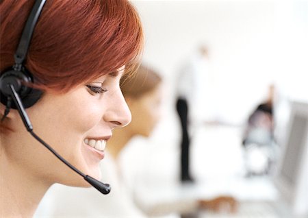 switchboard operator - Woman wearing headset in office, side view, close-up Stock Photo - Premium Royalty-Free, Code: 632-01145994