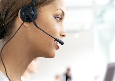 switchboard operator - Woman wearing headset in office, side view, close-up Stock Photo - Premium Royalty-Free, Code: 632-01145995