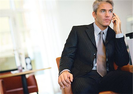 simsearch:632-03403433,k - Businessman sitting, talking on cell phone Stock Photo - Premium Royalty-Free, Code: 632-01148037