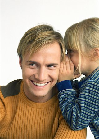 pictures of a little girl whispering - Child, side view, whispering into young man's ear, head and shoulders, close-up Stock Photo - Premium Royalty-Free, Code: 632-01148265