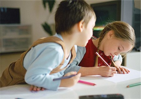 Young boy and girl drawing together, close up Stock Photo - Premium Royalty-Free, Code: 632-01148456