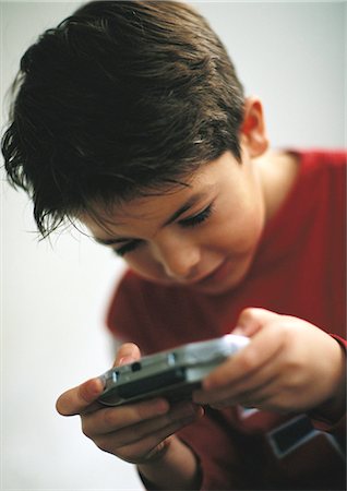 simsearch:632-03424261,k - Young boy playing video game, close up Stock Photo - Premium Royalty-Free, Code: 632-01149435