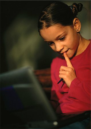 preteen girl mouth - Young girl looking down at computer, close up Stock Photo - Premium Royalty-Free, Code: 632-01149478