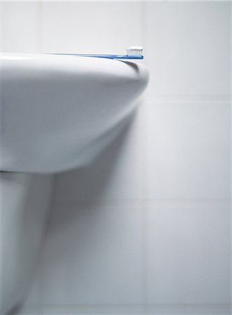 simsearch:696-03395895,k - Toothbrush laying on sink, partial view Stock Photo - Premium Royalty-Free, Code: 632-01149488