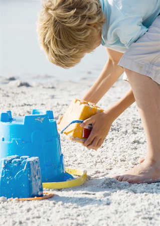 Child making sand castle Stock Photo - Premium Royalty-Free, Code: 632-01154718