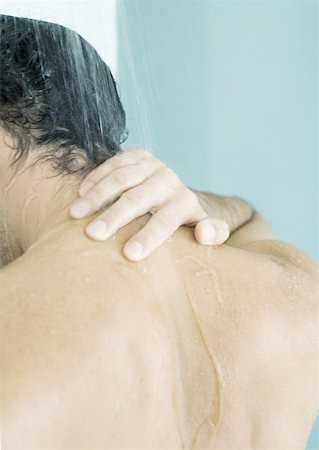 Man touching neck in shower Stock Photo - Premium Royalty-Free, Code: 632-01154757