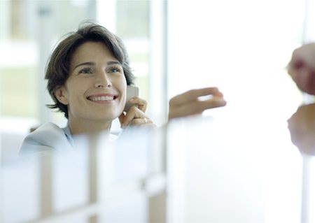 switchboard operator - Receptionist smiling, reflection in foreground Stock Photo - Premium Royalty-Free, Code: 632-01155785