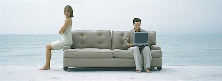 simsearch:632-01148228,k - On beach, couple sitting apart on sofa Stock Photo - Premium Royalty-Free, Code: 632-01156093