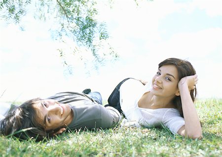 simsearch:633-01715612,k - Young couple lying on grass Stock Photo - Premium Royalty-Free, Code: 632-01156404