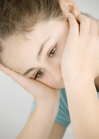 simsearch:695-03376367,k - Preteen girl holding head, looking down Stock Photo - Premium Royalty-Free, Code: 632-01156712